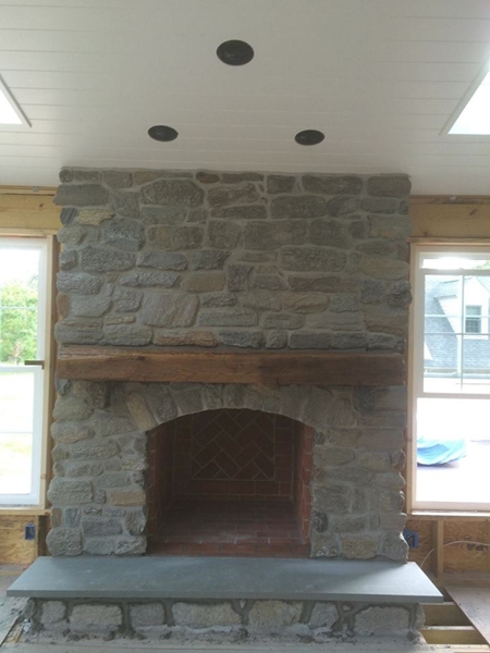 Our Dark Mica Stone Veneer on a fireplace with Bluestone Hearth stone